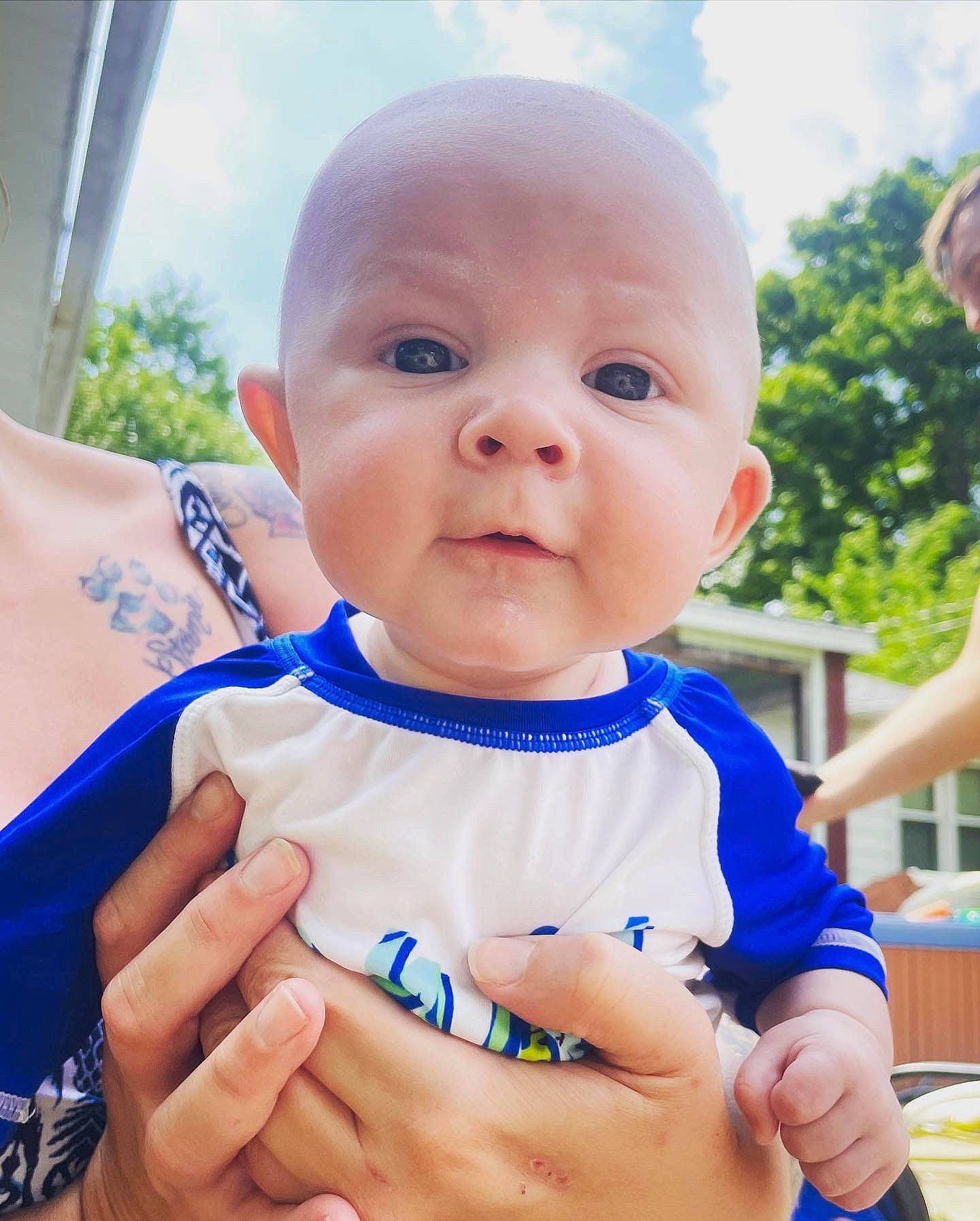 Grayson is registered to the contest to win money with this photo: baby, baby_toddler_clothing, blue, cheek, electric_blue, facial_expression, finger, hand, happy, iris, neck, nose, people_in_nature, person, skin, sky, sleeve, smile, t_shirt, thumb