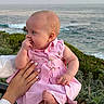 Leia is registered to the contest to win money with this photo: baby, child, pink_dress, ocean, sea, railing, hand, manicure, greenery, outdoor, nature, sunset, portrait, infant, cute, sitting, thoughtful, skin, person, scenery