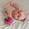 Leia is registered to the contest to win money with this photo: baby, pink, headband, cake, number_candle, bed, white_bed, infant, cute, portrait, sleepwear, child, celebration, birthday, lying_down, soft_fabric, indoors, adorable, young_child, head