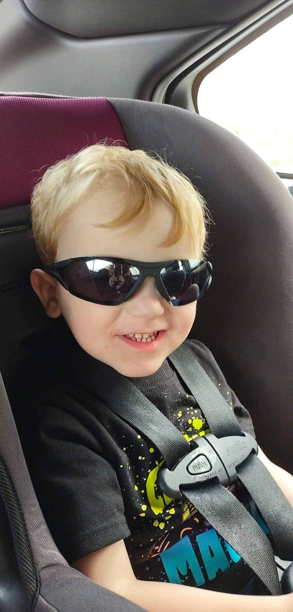 Malaki joined the competition — help win amazing prizes! auto_part, automotive_design, blond, car_seat, car_seat_cover, cool, eyewear, face, glasses, goggles, hairstyle, head, head_restraint, joy, motor_vehicle, person, personal_protective_equipment, seat_belt, smile, sunglasses