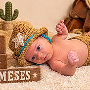 Kaylen is registered to the contest to win money with this photo: newborn, baby, infant, child, portrait, lying_down, crocheted_hat, cowboy_theme, diaper_cover, blanket, cactus, cowboy_boots, wooden_blocks, milestone, rustic, indoor, brown, blue_trim, photography, cute