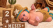Kaylen is registered to the contest to win money with this photo: newborn, baby, infant, child, portrait, lying_down, crocheted_hat, cowboy_theme, diaper_cover, blanket, cactus, cowboy_boots, wooden_blocks, milestone, rustic, indoor, brown, blue_trim, photography, cute