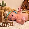 newborn, baby, infant, child, portrait, lying_down, crocheted_hat, cowboy_theme, diaper_cover, blanket, cactus, cowboy_boots, wooden_blocks, milestone, rustic, indoor, brown, blue_trim, photography, cute