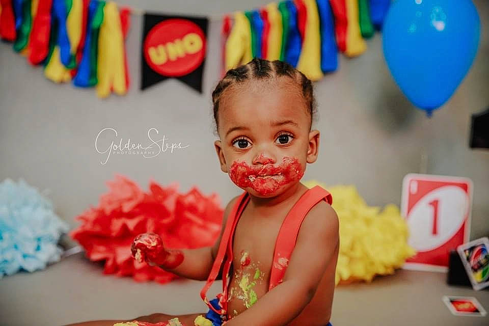 Kolby joined the competition — help win amazing prizes! artificial_flower, baby, balloon, birthday, birthday_party, cake, cake_decorating, cake_decorating_supply, cut_flowers, dessert, facial_expression, hair_accessory, icing, party, party_supply, person, pink, sweetness, toddler