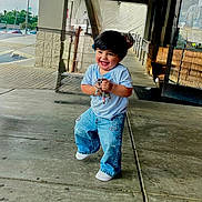Mteo is registered to the contest to win money with this photo: child, toddler, smiling, happy, jeans, tshirt, concrete, sidewalk, urban, building, door, glass, reflection, keys, playful, person, walking, outdoor, daylight, cute