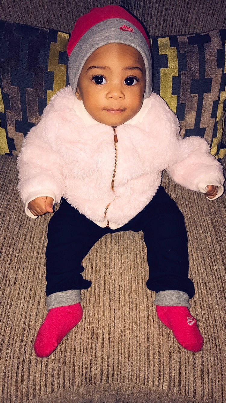 Vada is registered to the contest to win money with this photo: baby, cheek, child, head, headgear, headwear, leg, outerwear, person, pink, shoe, skin, toddler, toy