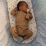 Elijah joined the competition — help win amazing prizes! baby, sleeping, pacifier, pajamas, bassinet, blanket, stars, moon, soft, cozy, infant, child, cute, resting, blue, brown, patterned, fabric, indoors, peaceful