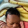 newborn, baby, sleeping, blanket, soft_texture, curly_hair, infant, peaceful, cute, skin, fist, closeup, portrait, child, resting, colorful, warm, cozy, indoors, toddler