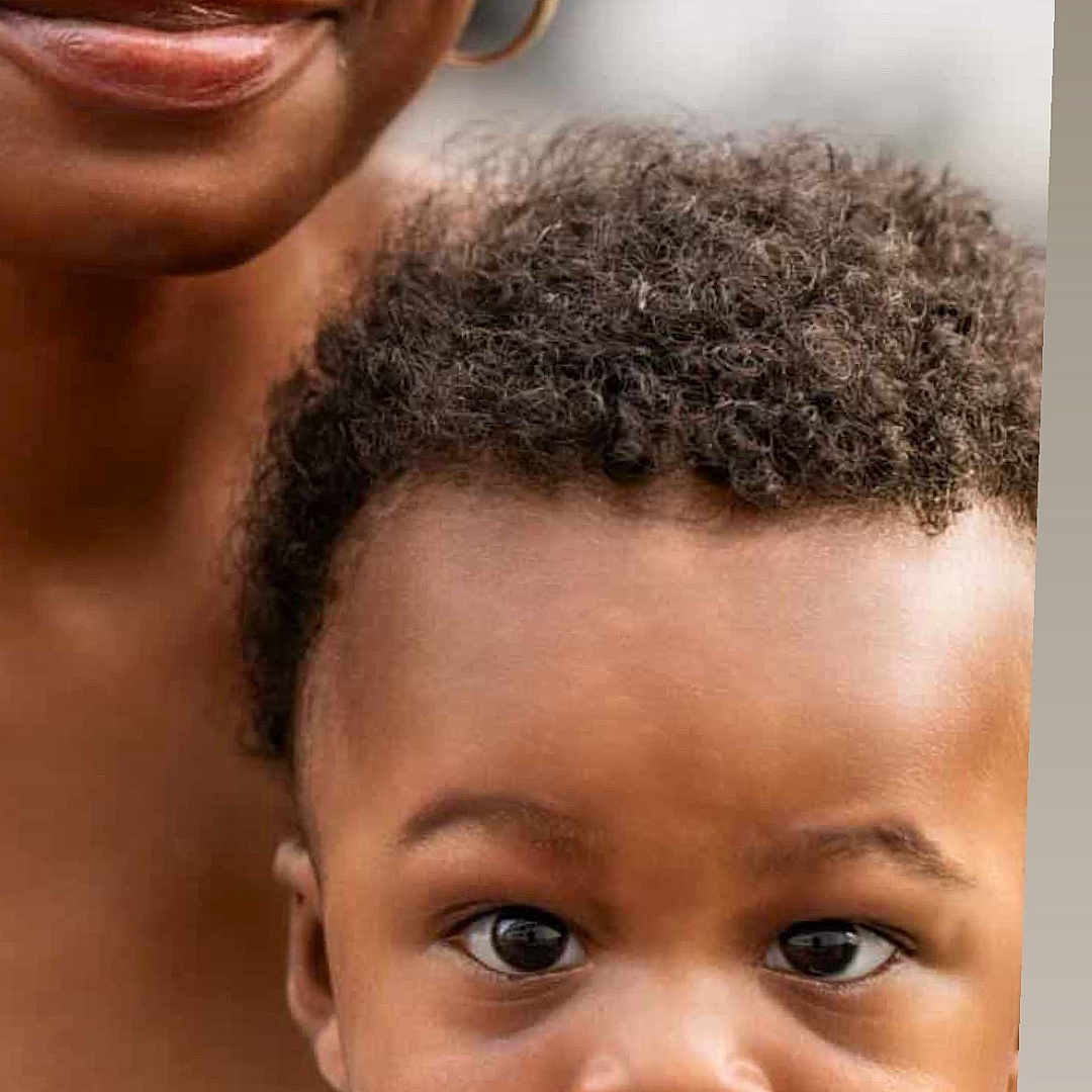 Blessan is registered to the contest to win money with this photo: child, toddler, adult, face, portrait, curly_hair, smile, close_up, person, skin, expression, clothing, earring, nose_ring, background_blur, human, family, love, emotion, people