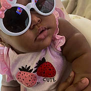 Ava joined the competition — help win amazing prizes! accessory, adorable, baby, child, closeup, cute, eyewear, face, fashion, hand, holding, indoor, infant, outfit, person, pink, skin, soft, strawberry, sunglasses