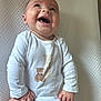 Lowen joined the competition — help win amazing prizes! baby, infant, smiling, laughing, onesie, white_clothing, teddy_bear, cute, happy, child, portrait, indoor, lying_down, texture, soft_surface, hands, legs, skin, expression, joy