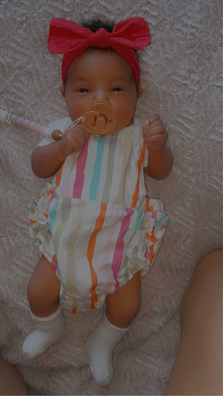 Atlas is registered to the contest to win money with this photo: baby, baby_toddler_clothing, cap, cheek, child, eye, face, headgear, human_body, human_leg, lip, magenta, pattern, person, pink, skin, sleeve, textile, thigh, thumb