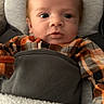 Declan joined the competition — help win amazing prizes! baby, infant, car_seat, blanket, orange_clothing, gray_fabric, face, eyes, portrait, screenshot, mobile_interface, button, text_overlay, cozy, soft_texture, child, cute, indoor, seat, young