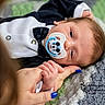 Declan is registered to the contest to win money with this photo: baby, infant, pacifier, mickey_mouse, tuxedo_onesie, hand_holding, blue_nail_polish, knitted_blanket, portrait, closeup, cute, sleepy, child, person, indoor, soft_lighting, newborn, baby_clothing, tender_moment, resting