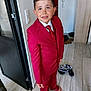 barefoot, boy, cabinet, casual, child, clothing, curious, door, expression, floor, footwear, home, indoor, person, portrait, red_suit, slippers, standing, tie, tiles