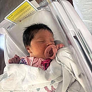 Scarlett is registered to the contest to win money with this photo: newborn, baby, sleeping, pacifier, hospital, blanket, bassinet, infant, face, person, pillow, clothing, pink, white, hospital_bed, child, cute, peaceful, wrapped, indoors
