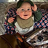 baby, child, smiling, cap, bib, blanket, stars, tent, indoor, happy, blue_eyes, cheeky, clothing, person, face, hand, sitting, bag, camping, cozy