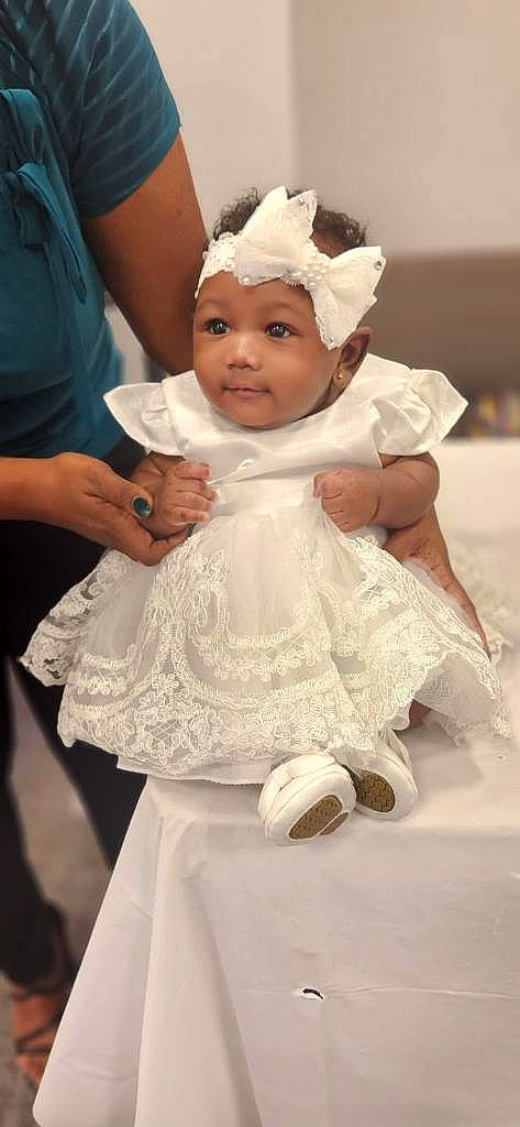 Amaya is registered to the contest to win money with this photo: baby, bridal_accessory, bridal_clothing, child, clothing, dress, embellishment, event, eye, fashion_design, finger, formal_wear, gesture, gown, happy, headpiece, headwear, person, pink, skin