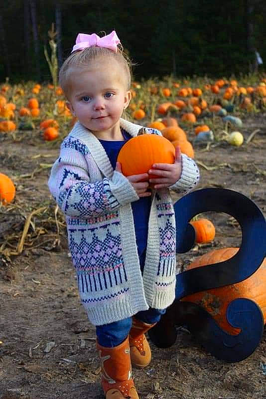 Ensley joined the competition — help win amazing prizes! calabaza, child, cucurbita, fruit, gourd, person, plant, pumpkin, squash, toddler, vegetable, winter_squash