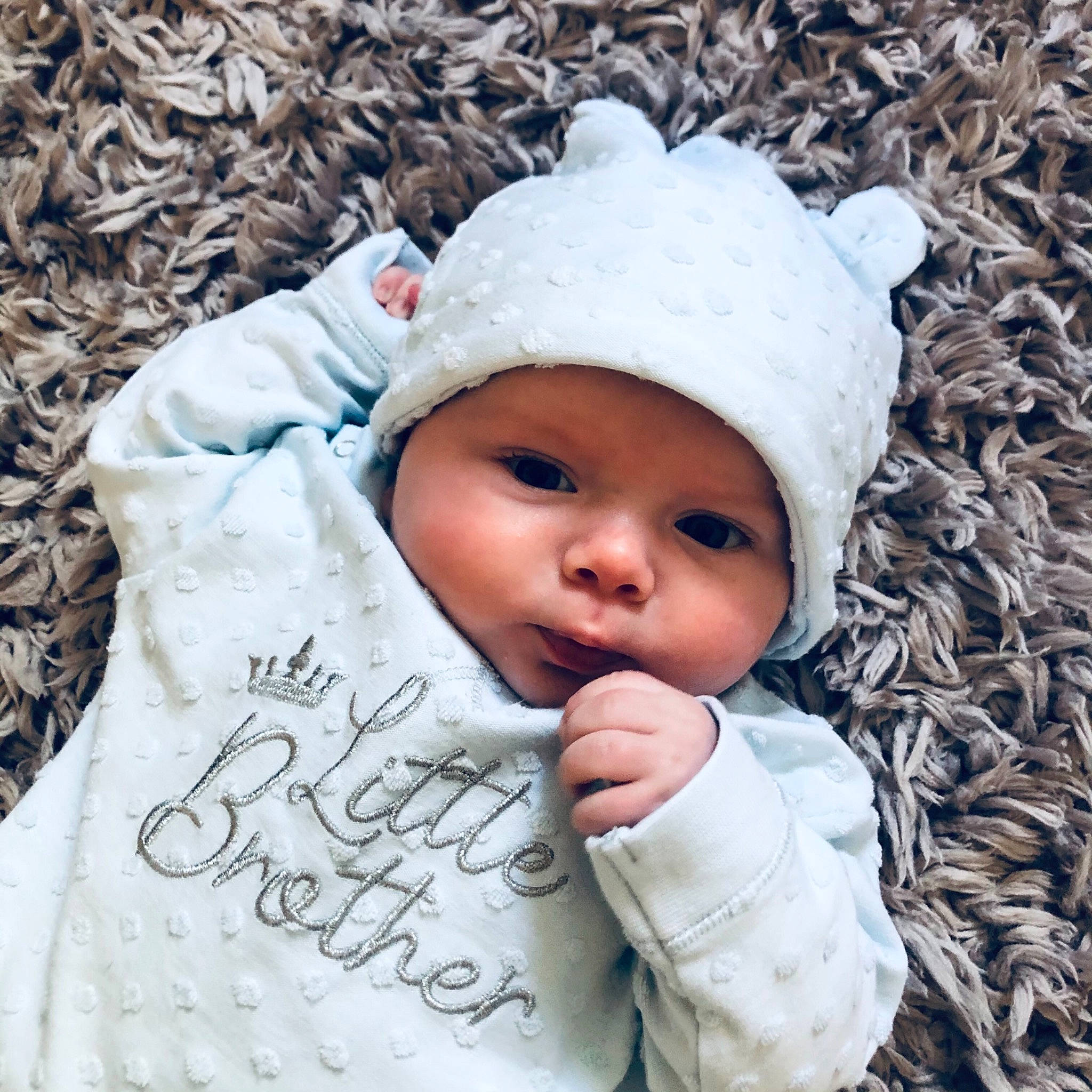 Teddy is registered to the contest to win money with this photo: baby, baby_toddler_clothing, cap, cheek, eye, face, freezing, grass, happy, head, headwear, knit_cap, lip, outerwear, people_in_nature, person, skin, sleeve, textile, toddler