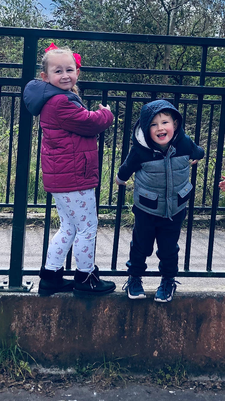 Charlie joined the competition — help win amazing prizes! baby_toddler_clothing, child, cool, eye, fence, fun, gesture, grass, happy, headwear, jacket, joy, leg, leisure, people_in_nature, person, photograph, plant, smile, sneakers