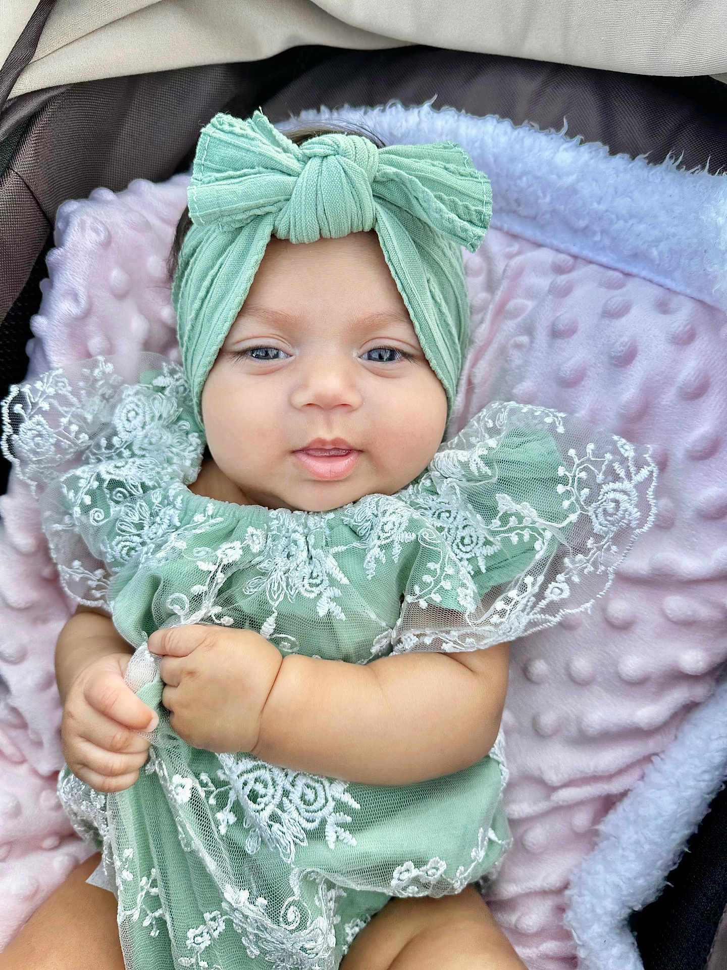 Alisha joined the competition — help win amazing prizes! baby, infant, child, headband, bow, green_clothing, lace, blanket, pink_blanket, cute, portrait, closeup, soft_texture, hand, smile, face, eyes, sitting, indoors, adorable