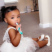 Azaria joined the competition — help win amazing prizes! toddler, child, white_dress, carpet, toothbrush, sitting, indoors, curly_hair, shoes, playful, cute, home, floor, window_blinds, furniture, portrait, young_child, baby, person, smiling