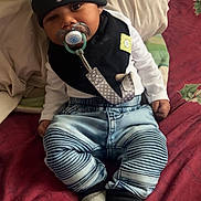 Tayden is registered to the contest to win money with this photo: baby, bed, bodypart, cap, clothing, coat, couch, cushion, face, furniture, hat, head, homedecor, jacket, jeans, pants, person, photography, portrait, sitting