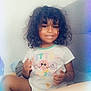 bodypart, child, clothing, couch, cushion, face, female, finger, furniture, girl, hand, happy, head, person, photography, portrait, shorts, sitting, smile, t_shirt