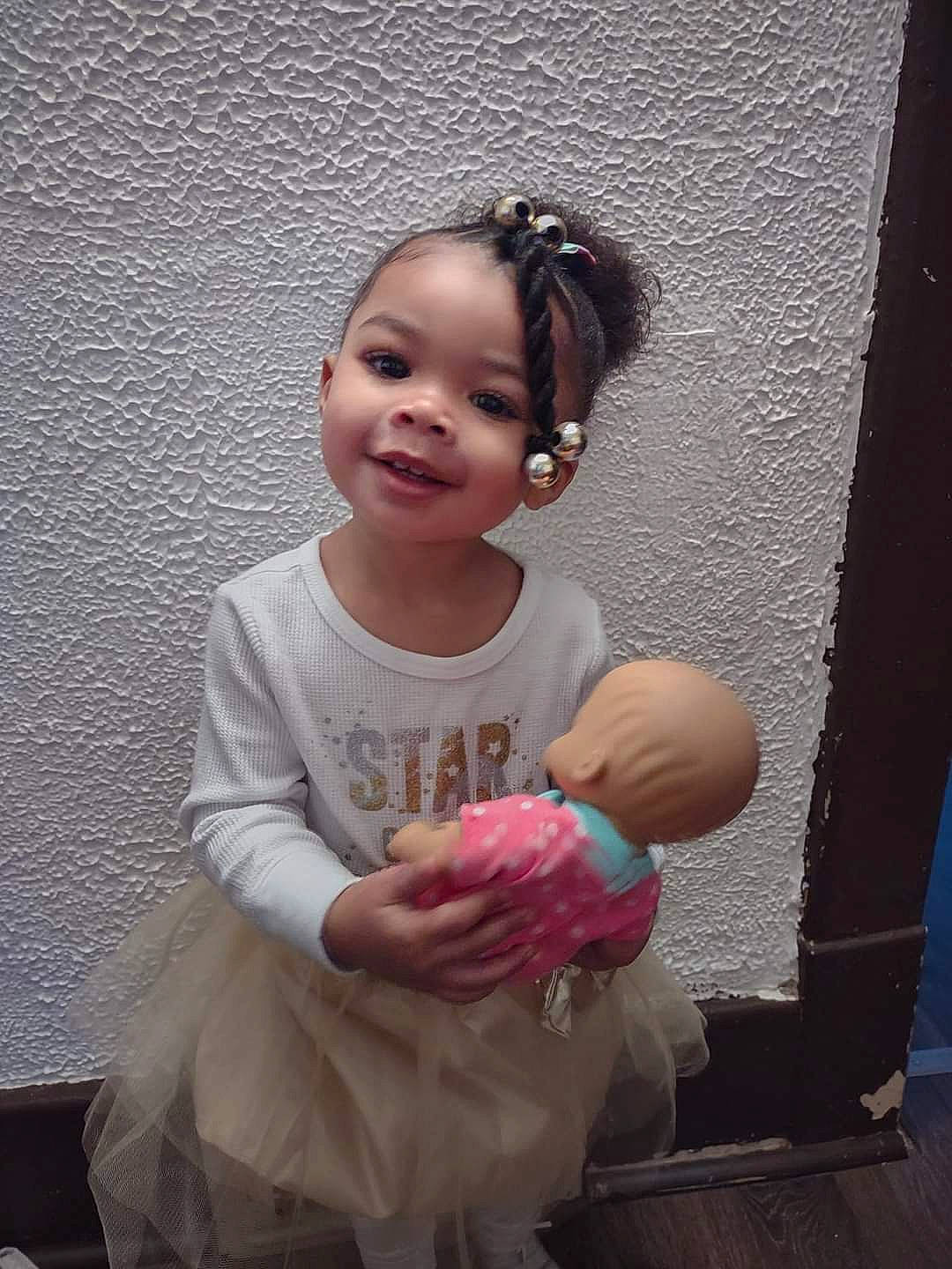 Janessa is registered to the contest to win money with this photo: baby_toddler_clothing, cheek, child, face, flash_photography, fun, gesture, hairstyle, happy, head, human_body, joy, magenta, neck, person, pink, purple, shoulder, skin, sleeve