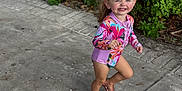Maelynn joined the competition — help win amazing prizes! child, girl, smile, outdoor, concrete, plants, greenery, footwear, sandals, swimsuit, happy, cute, playful, sunny, nature, walking, joy, summer, portrait, casual