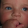 baby, child, infant, face, portrait, close_up, blue_eyes, fist, hand, chewing, curious, wide_eyes, eyebrows, nose, mouth, skin, indoor, photography, adorable, head