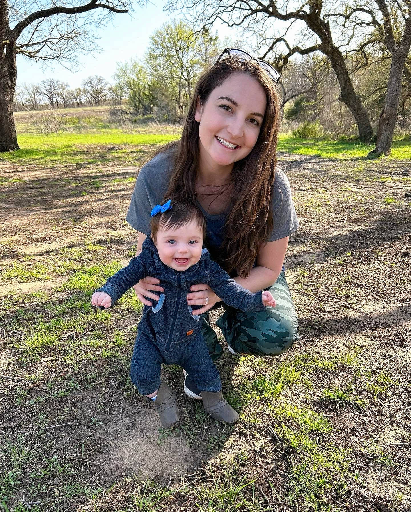 Eve is registered to the contest to win money with this photo: botany, branch, child, eye, forest, fun, grass, grassland, happy, joy, leisure, natural_landscape, people_in_nature, person, plant, sky, smile, soil, toddler, tree