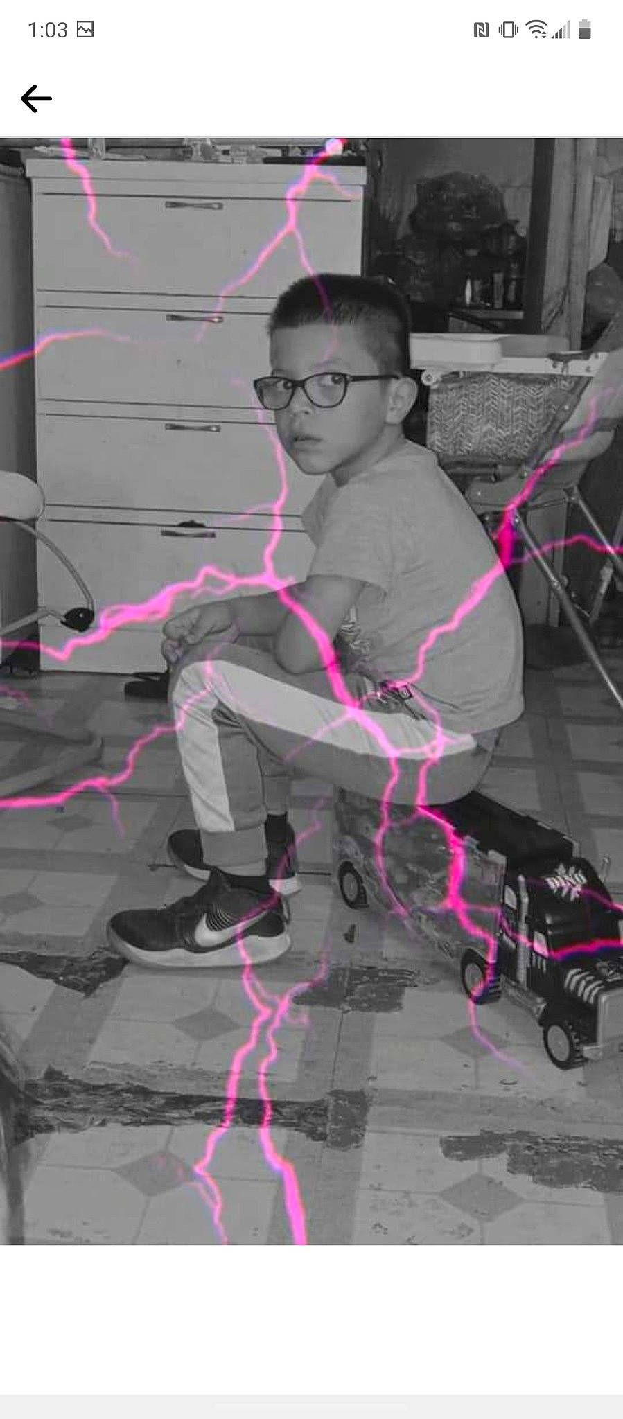 Donovan is registered to the contest to win money with this photo: audio_equipment, boot, cool, entertainment, event, eyewear, fun, magenta, person, pink, purple, recreation, shadow, sitting, toy, vision_care, visual_arts