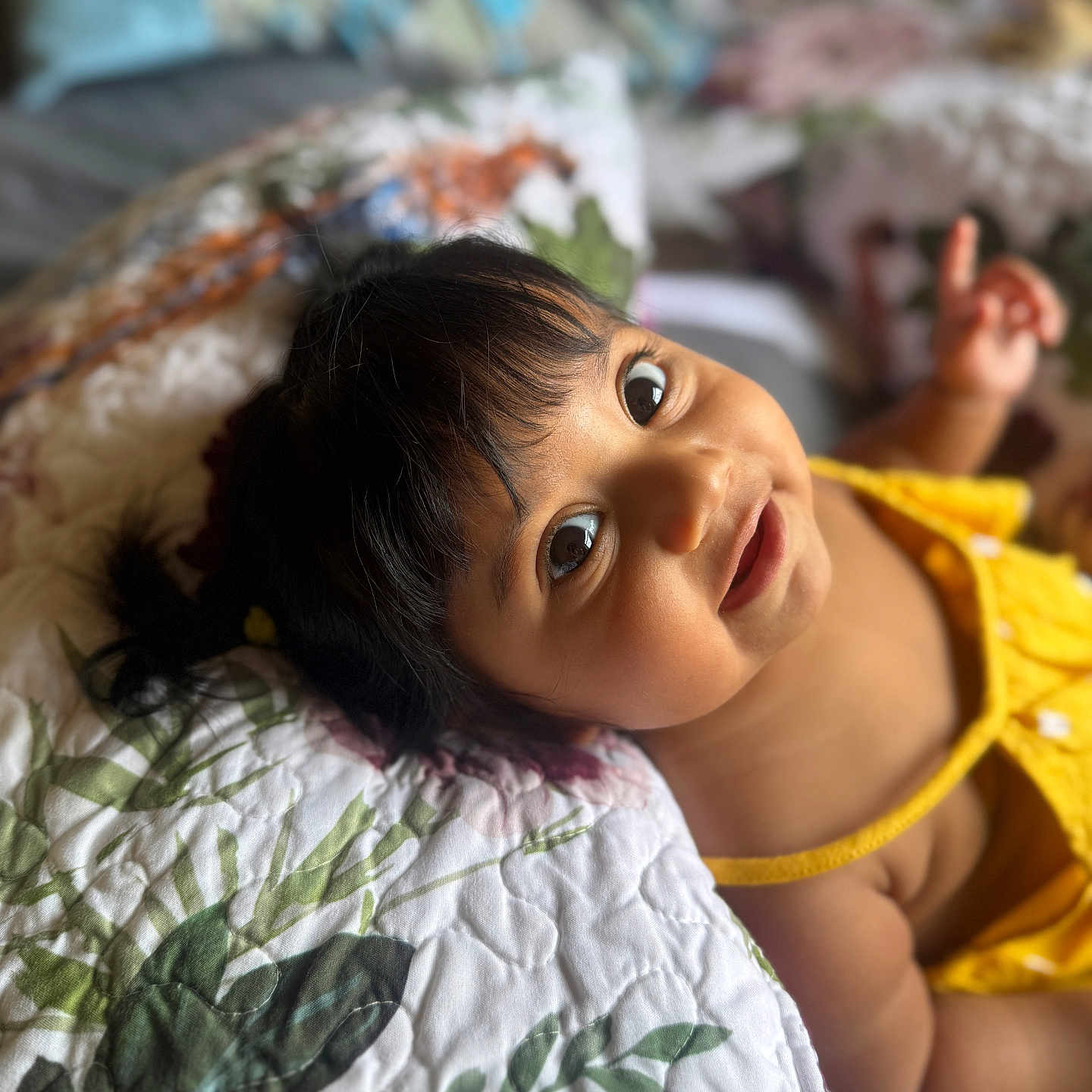 Skyrah joined the competition — help win amazing prizes! baby, bed, child, cute, expression, face, floral, hair, hand, happy, indoors, infant, lying_down, person, portrait, quilt, skin, smile, yellow_clothing, young_child