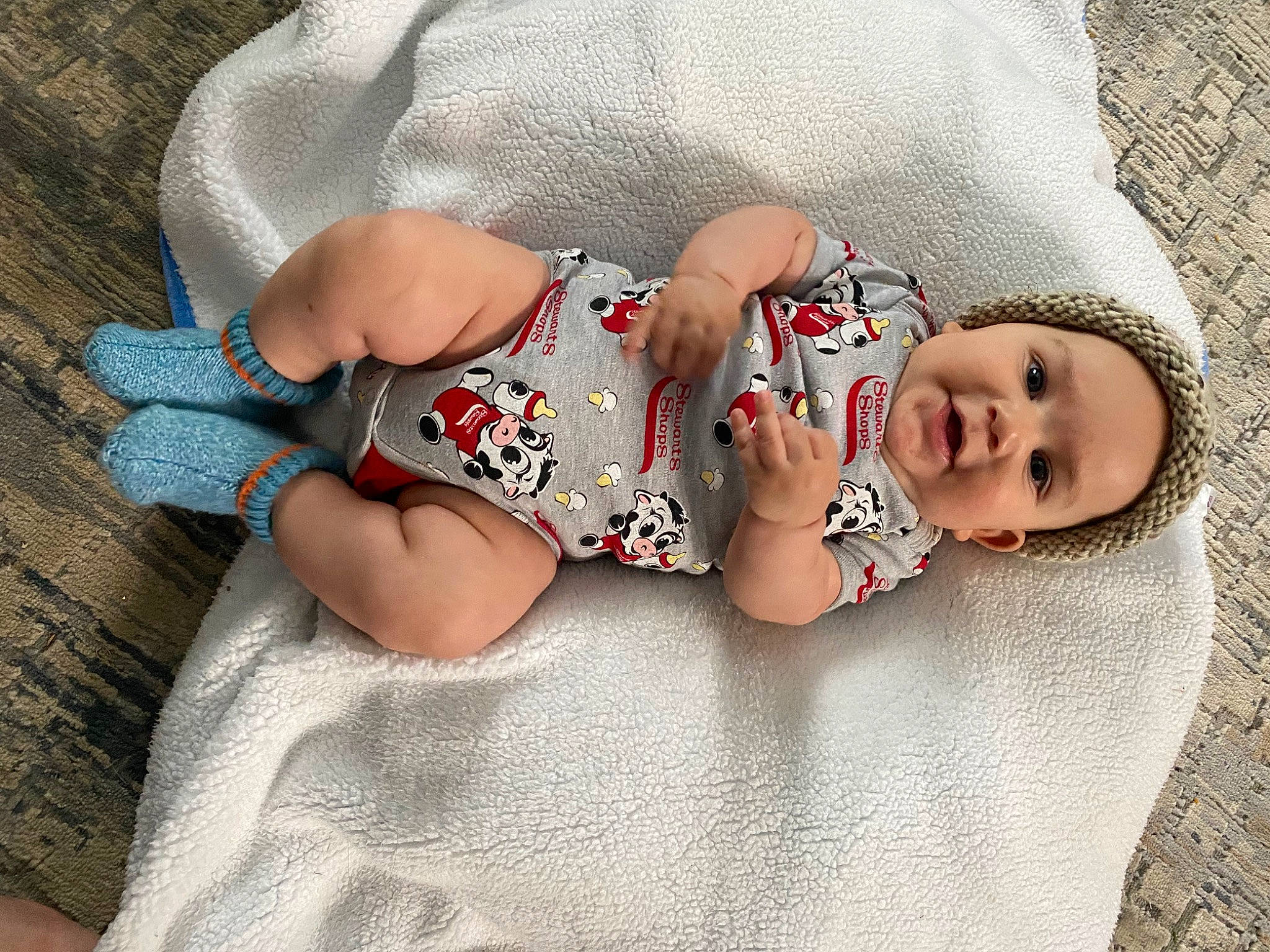 Desmond is registered to the contest to win money with this photo: baby, baby_sleeping, baby_toddler_clothing, child, comfort, eye, foot, grey, head, headwear, human_body, human_leg, infant_bodysuit, leg, linens, pattern, person, skin, sleeve, sock