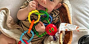 Kendan joined the competition — help win amazing prizes! baby, infant, toy, colorful, rings, chewing, blanket, cushion, seat, carpet, clothing, hand, foot, indoor, cute, child, face, expression, comfort, playtime
