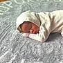 baby, newborn, sleeping, blanket, knitwear, hood, infant, soft, cozy, resting, face, portrait, peaceful, indoor, floor, wooden_floor, closeup, cute, child, warm