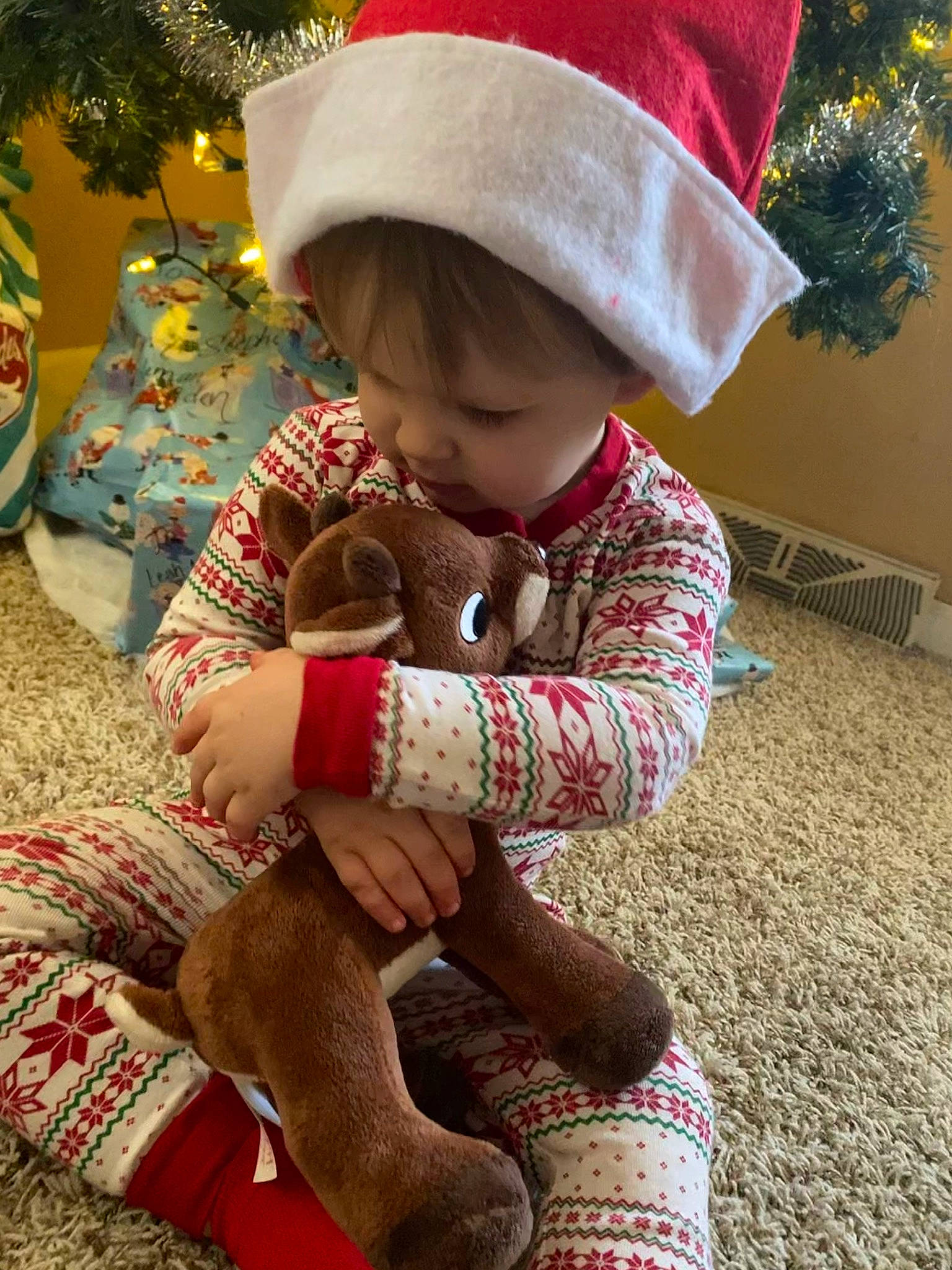 Zaiden joined the competition — help win amazing prizes! baby, baby_toddler_clothing, child, christmas, christmas_eve, comfort, event, flooring, foot, fun, grass, happy, holiday, human_leg, lap, pattern, person, sitting, skin, thigh