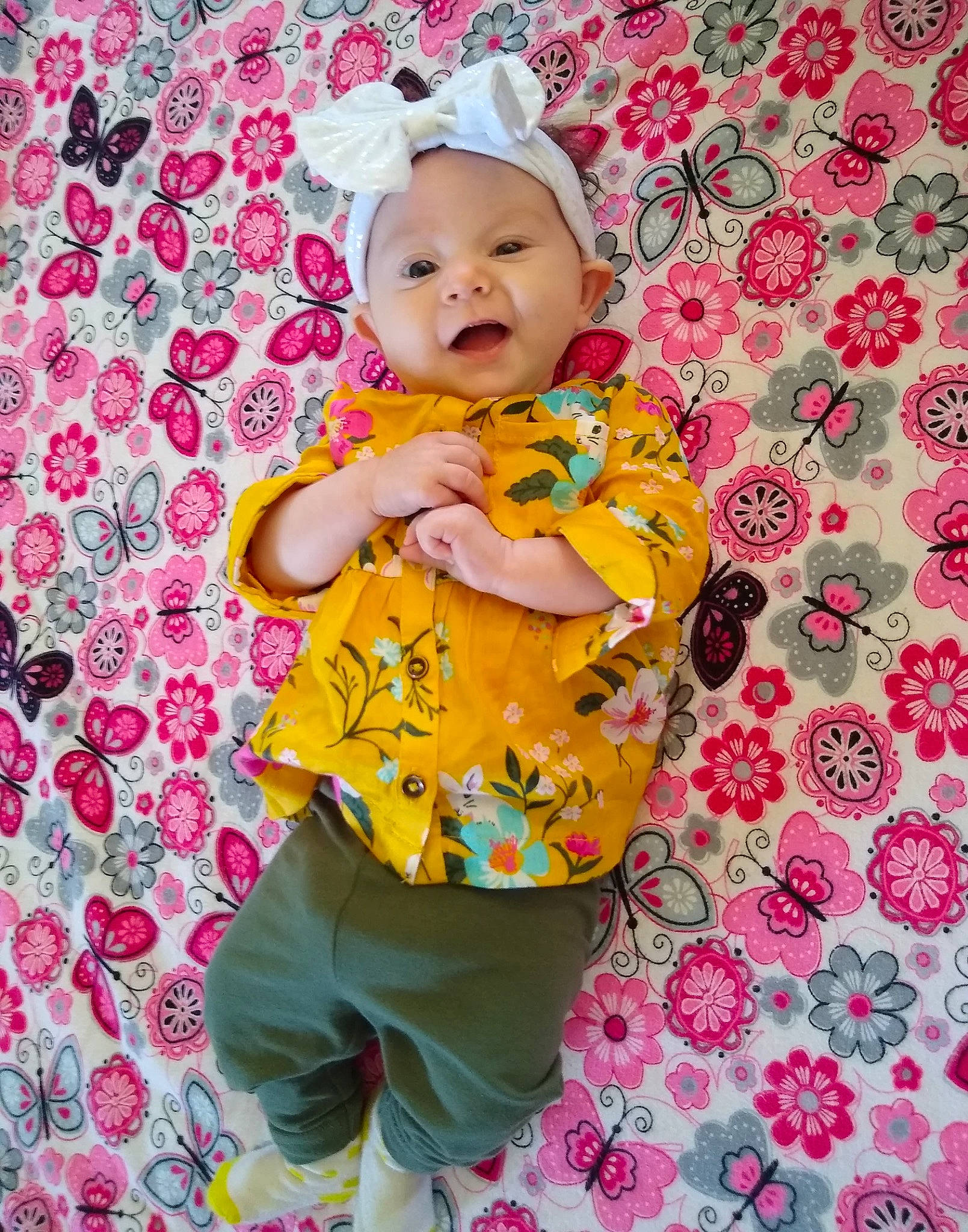 Stormi joined the competition — help win amazing prizes! baby, baby_products, baby_toddler_clothing, cheek, child, headwear, pattern, person, pink, product, skin, sleeve, smile, textile, toddler, yellow