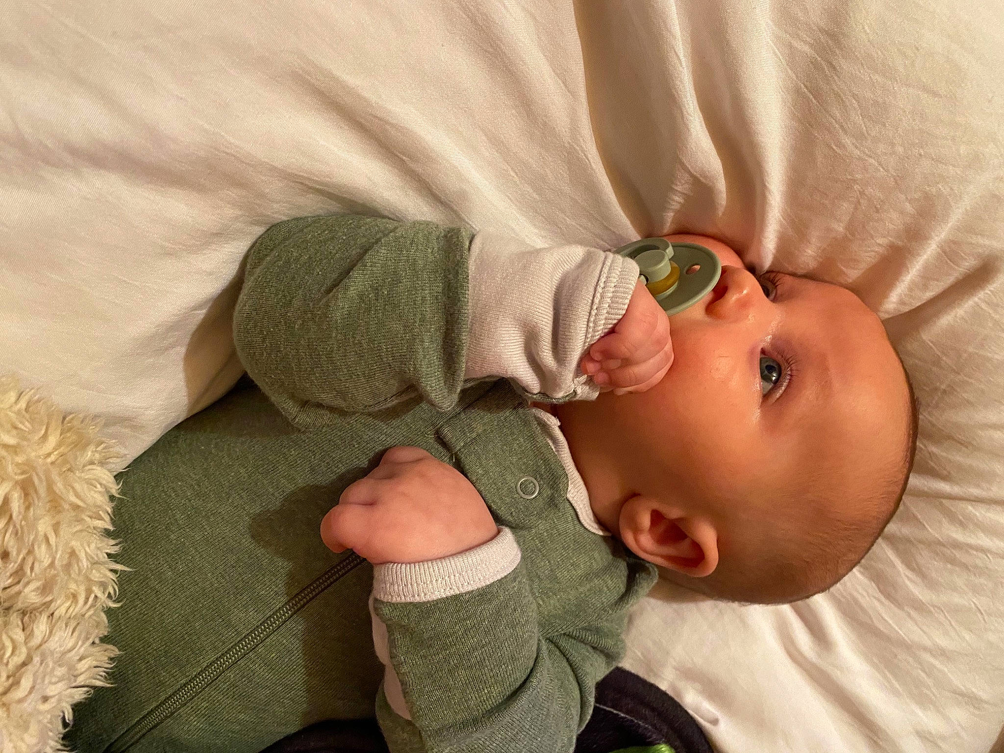 Colin is registered to the contest to win money with this photo: arm, baby, baby_products, baby_sleeping, baby_toddler_clothing, bedtime, child, comfort, ear, grass, headgear, linens, nap, nose, pattern, person, skin, sleeve, sunglasses, textile