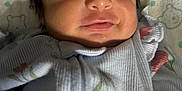 Serenity joined the competition — help win amazing prizes! baby, sleeping, infant, face, clothing, pillow, pattern, floral, cute, peaceful, closeup, soft, smile, newborn, person, resting, indoors, child, young, blanket