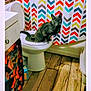 animal, bathroom, cabinet, cat, chevron_pattern, colorful, curious, feline, floor_tiles, gray_cat, home, indoor, looking, pattern, pet, plumbing, shower_curtain, sink, toilet, whiskers