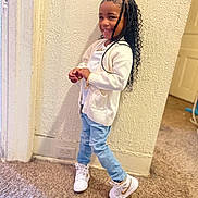 Sayori joined the competition — help win amazing prizes! child, smiling, indoor, carpet, white_cardigan, light_blue_jeans, white_sneakers, braided_hair, textured_wall, door, power_outlet, playful_pose, happy, person, young, casual_clothing, standing, fashion, accessories, home