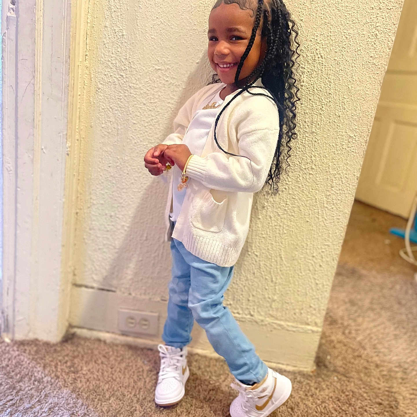 Sayori joined the competition — help win amazing prizes! child, smiling, indoor, carpet, white_cardigan, light_blue_jeans, white_sneakers, braided_hair, textured_wall, door, power_outlet, playful_pose, happy, person, young, casual_clothing, standing, fashion, accessories, home