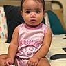 baby, child, infant, girl, pink_clothing, minnie_mouse, sitting, bed, pillow, cute, indoors, portrait, young_child, hair_tie, socks, curious, face, person, soft_focus, home