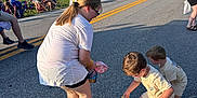 Lane joined the competition — help win amazing prizes! child, children, parade, street, candy, bag, crowd, daylight, outdoor, people, grass, car, house, road, sidewalk, clothing, shoes, glasses, fun, event