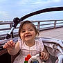 Isla is registered to the contest to win money with this photo: baby, beverage, bodypart, coffee, coffeecup, couch, cup, face, finger, furniture, hand, happy, head, person, photography, portrait, railing, smile, stroller, toy