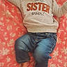 baby, child, sleeping, portrait, bow, headband, knitwear, long_sleeves, jeans, floral_blanket, pink, indoors, lying_down, arms_outstretched, closed_eyes, peaceful, infant, clothing, sister_shirt, cozy