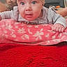Athena joined the competition — help win amazing prizes! baby, child, infant, portrait, wide_eyed, bow, headband, gray_shirt, blanket, floral_pattern, red_carpet, indoor, home, furniture, couch, adult, face, hands, sitting, cute